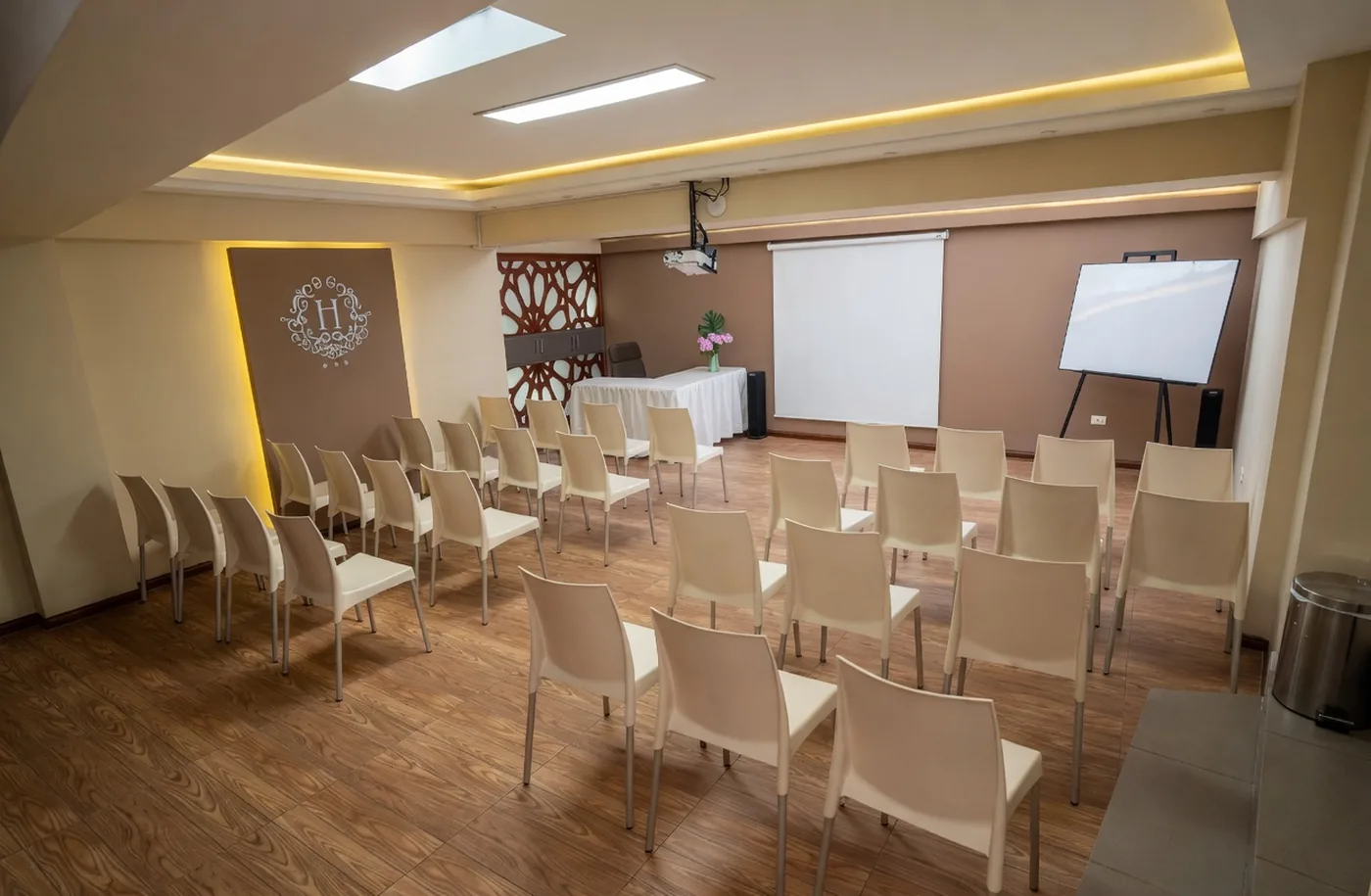 Conference room at Munay Wasi Inn in Cusco with seating set for a meeting, warm wood details, and natural light.