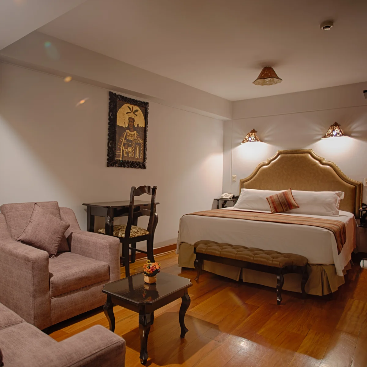 Junior Suite at Munay Wasi Inn in Cusco with a queen bed, 175 square feet, private bathroom, sofa, minibar, and free Wi-Fi for two guests.
